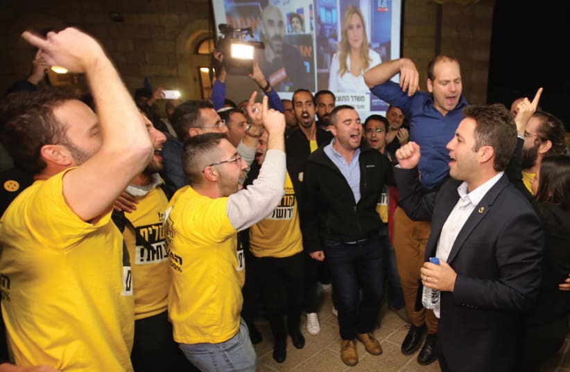 Ofer Berkovitch (right) and some supporters on election day, celebrating the news he would be moving on to the second round. (photo credit: MARC ISRAEL SELLEM)
