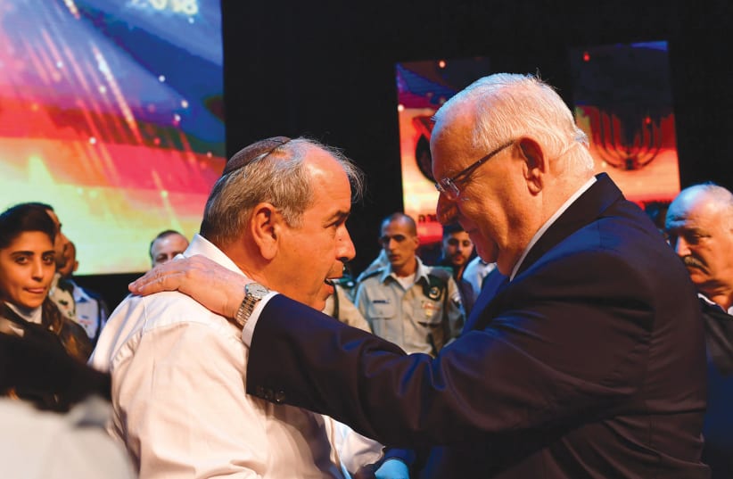 PRESIDENT REUVEN RIVLIN embraces David Malka, the father of the late Hadas Malka (photo credit: KOBI GIDEON/GPO)