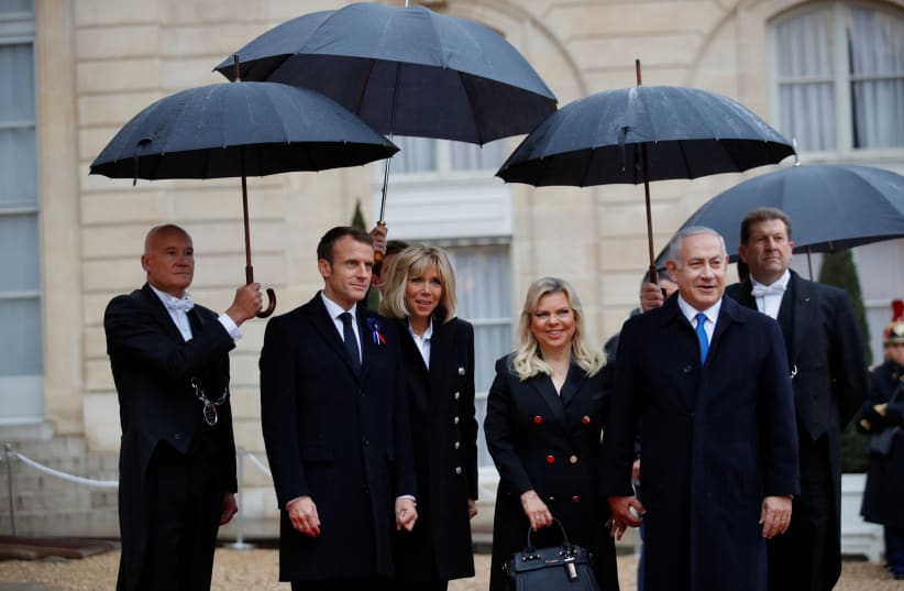 French President Emmanuel Macron and his wife Brigitte Macron welcome Israel Prime Minister Benjamin Netanyahu and his wife Sara at the Elysee Palace as part of the commemoration ceremony for Armistice Day, 100 years after the end of the First World War, in Paris, France, November 11, 2018. (photo credit: PHILIPPE WOJAZER/REUTERS)
