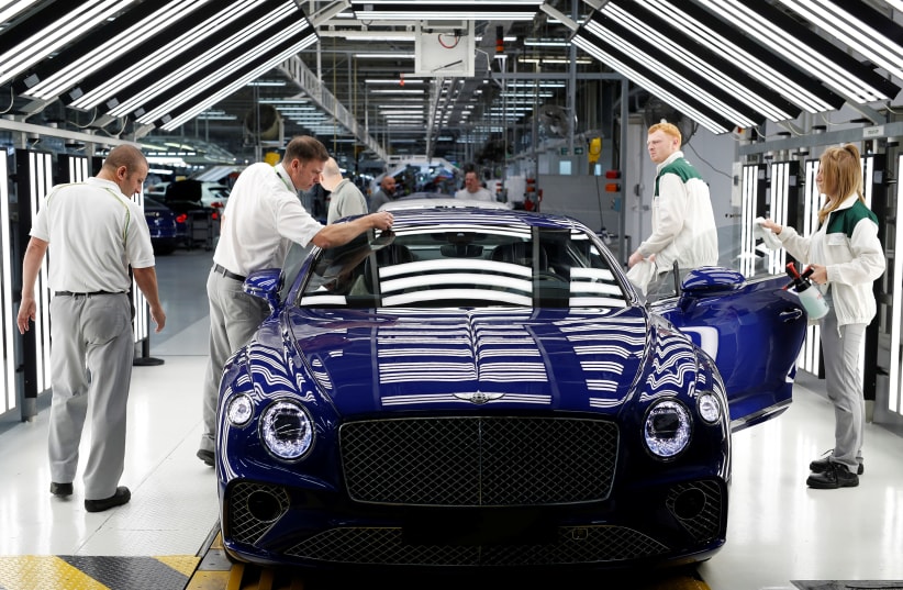 Workers inspect a Bentley Continental GT at the luxury automaker's manufacturing facility in Crewe, Britain October 15, 2018. Picture taken October 15, 2018.  (photo credit: DARREN STAPLES/REUTERS)