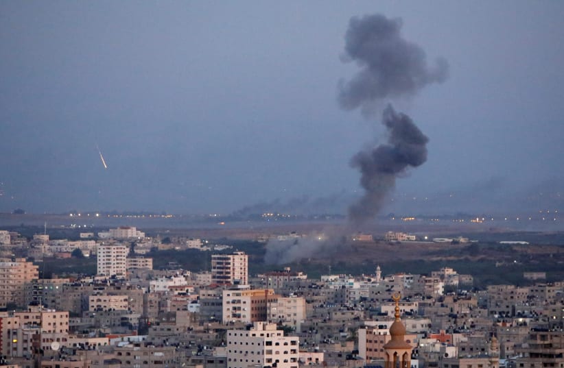 Smoke rises during an Israeli air strike in Gaza, November 12, 2018 (photo credit: AHMED ZAKOT / REUTERS)