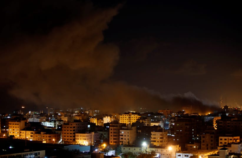 Smoke rises following an Israeli air strike on Hamas's television station, in Gaza City, November 12, 2018 (photo credit: AHMED ZAKOT / REUTERS)