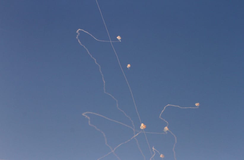 Missiles from Israel's Iron Dome air defence system in the south of Israel destroy incoming missiles fired at Israel from the Palestinian enclave of Gaza above Ashkelon on November 13, 2018 (photo credit: GIL COHEN MAGEN / AFP)