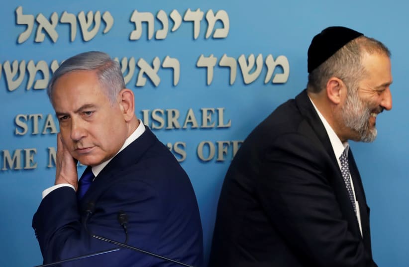 Israeli Prime Minister Benjamin Netanyahu and Israeli Interior Minister Aryeh Deri are seen at the end of a news conference at the Prime Minister's office in Jerusalem, April 2, 2018. (photo credit: RONEN ZVULUN/REUTERS)