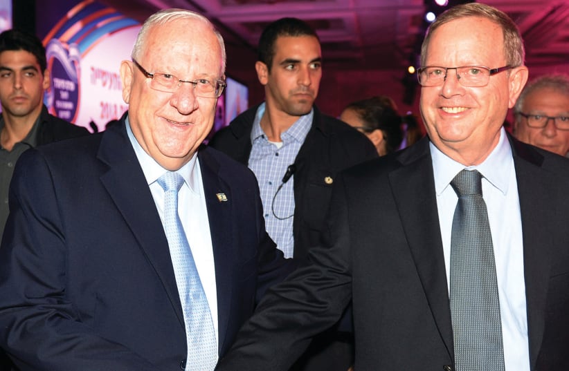 President Reuven Rivlin congratulates Ben and Jerry's Israel CEO Avi Zinger  (photo credit: MORAG BITAN)