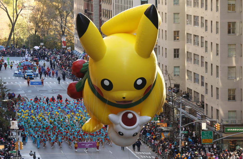 The Pikachu balloon make its way down 6th Ave during the 91st Macy's Thanksgiving Day Parade in the Manhattan borough of New York City, New York, U.S., November 23, 2017 (photo credit: REUTERS/CARLO ALLEGRI)