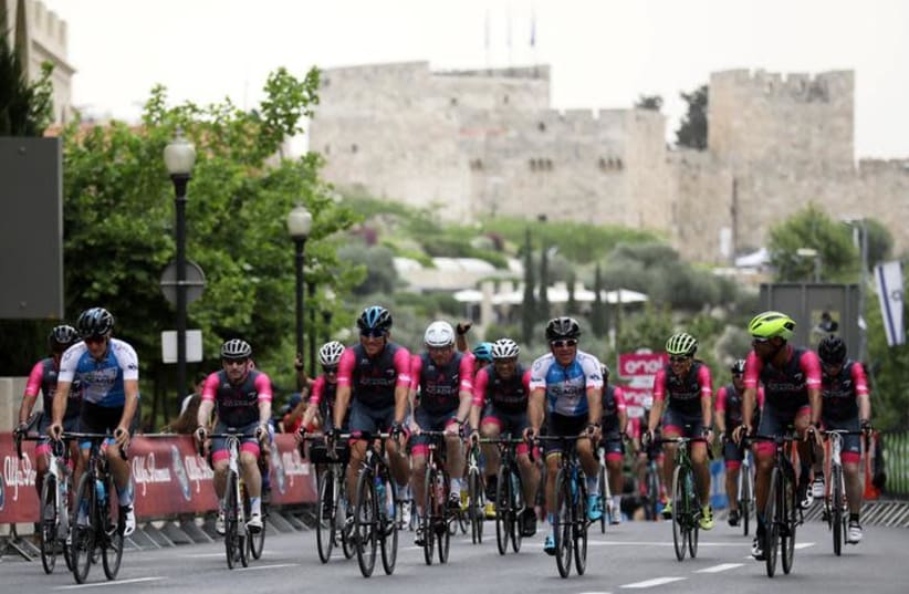  Sylvan Adams (C, blue), honorary president of Giro d'Italia's "Big Start" Israel, rides before the begining of the stage at the 101st Giro d'Italia cycling race in Jerusalem, May 4, 2018 (photo credit: AMMAR AWAD / REUTERS)