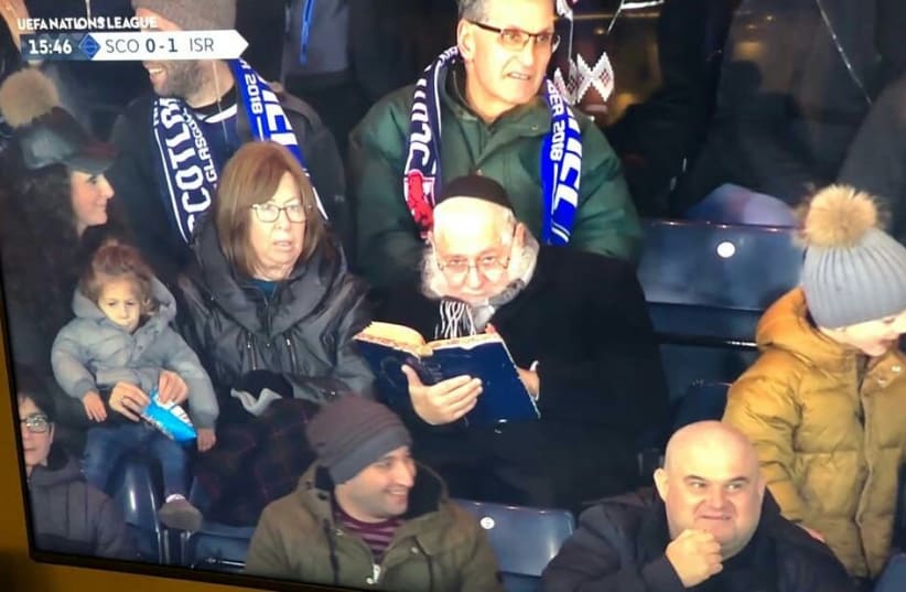 Rabbi studying during ISR-SCO game goes viral (photo credit: EYTAN HALON)