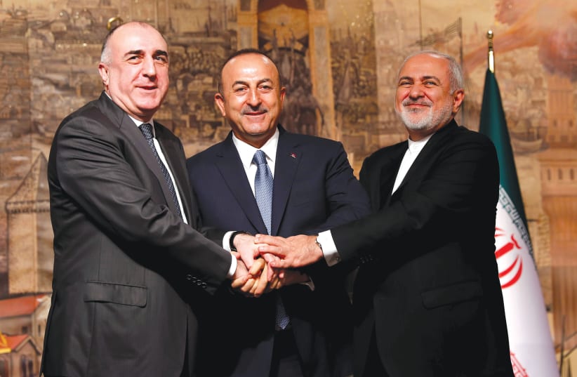 TURKISH FOREIGN Minister Mevlut Cavusoglu (center) poses with his counterparts Elmar Mammadyarov of Azerbaijan (left) and Javad Zarif of Iran following a news conference in Istanbul, Turkey in October. (photo credit: REUTERS)
