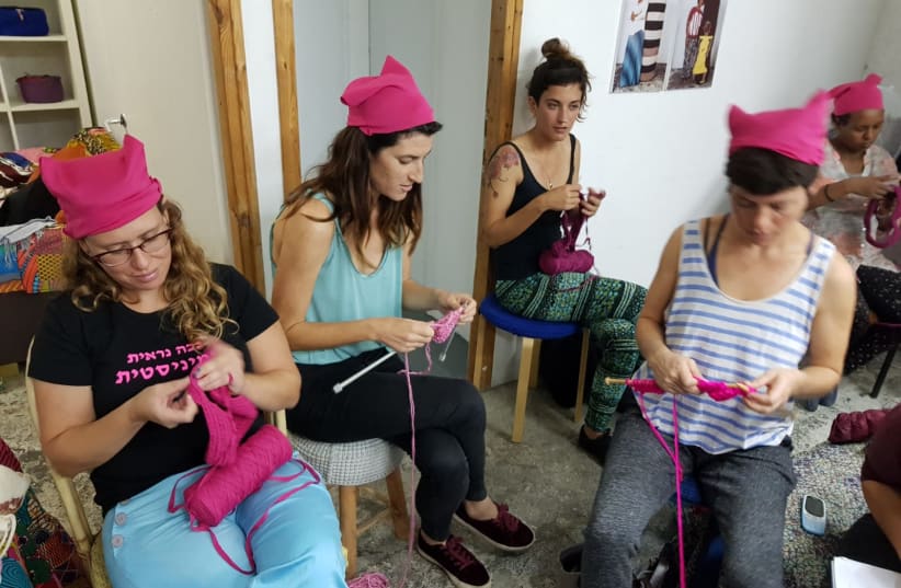Women knit pink hats with member of the Kuchinate, the African Refugee Women's Collective, in south Tel Aviv (photo credit: TEL AVIV SEXUAL ASSAULT CRISIS CENTER)
