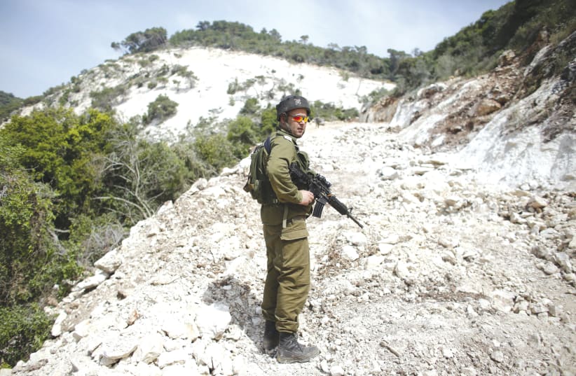AN IDF soldier on guard – the enemy on one side and attorneys on the other? (photo credit: REUTERS/Ronen Zvulun)