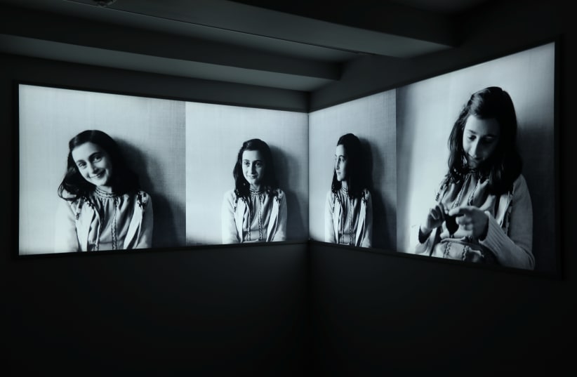 Photos of Anne Frank are seen at Anne Frank House museum in Amsterdam, Netherlands, November 21, 2018. (photo credit: REUTERS/EVA PLEVIER)