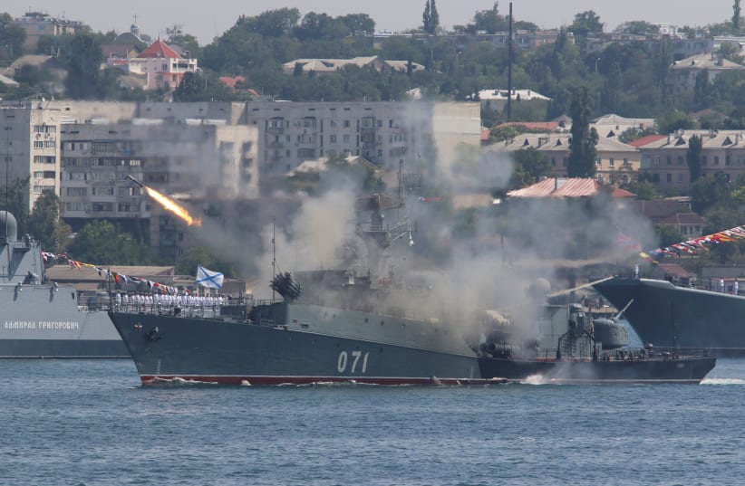 The Russian small anti-submarine ship Suzdalets fires a missile during a rehearsal for the Navy Day parade in the Black Sea port of Sevastopol, Crimea, July 27, 2017 (photo credit: PAVEL REBROV/REUTERS)