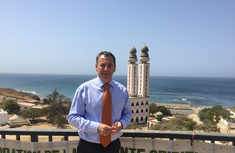 AMBASSADOR PAUL HIRSCHSON in front of the iconic Mosque of the Divinity in Dakar (photo credit: SETH J. FRANTZMAN)