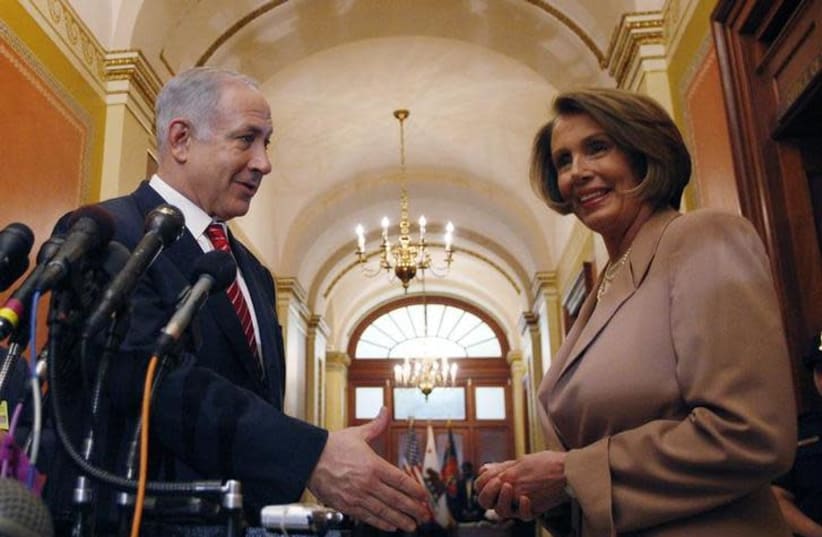 Israeli Prime Minister Benjamin Netanyahu reaches out to shake hands with Nancy Pelosi, Speaker of the U.S. House of Representatives, before their meeting on Capitol Hill in Washington May 19, 2009 (photo credit: JASON REED/REUTERS)