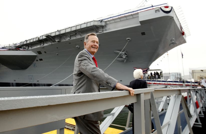 Former President George Bush walks the gangway as he arrives for the christening ceremony of the USS George H.W. Bush at Northrop-Grumman's shipyard in Newport News, Virginia, October 7, 2006 (photo credit: KEVIN LAMARQUE/REUTERS)