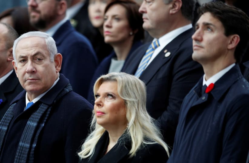 Israeli Prime Minister Benjamin Netanyahu, and his wife Sara, with Canadian Prime Minister Justin Trudeau attend a commemoration ceremony for Armistice Day, 100 years after the end of the First World War at the Arc de Triomphe, in Paris, France, November 11, 2018 (photo credit: FRANCOIS MORI/REUTERS)