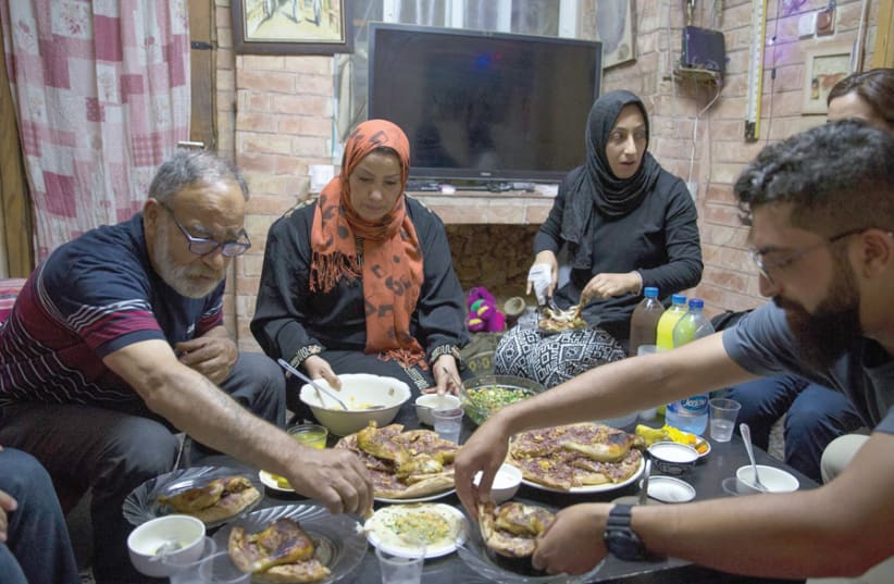 A Muslim family hosts Jewish Israelis at the traditional Iftar evening meal during Ramadan. (photo credit: OPEN HOLIDAYS)