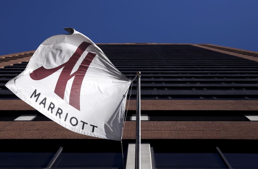 A Marriott flag hangs at the entrance of the New York Marriott Downtown hotel in Manhattan, New York November 16, 2015 (photo credit: REUTERS/ANDREW KELLY)