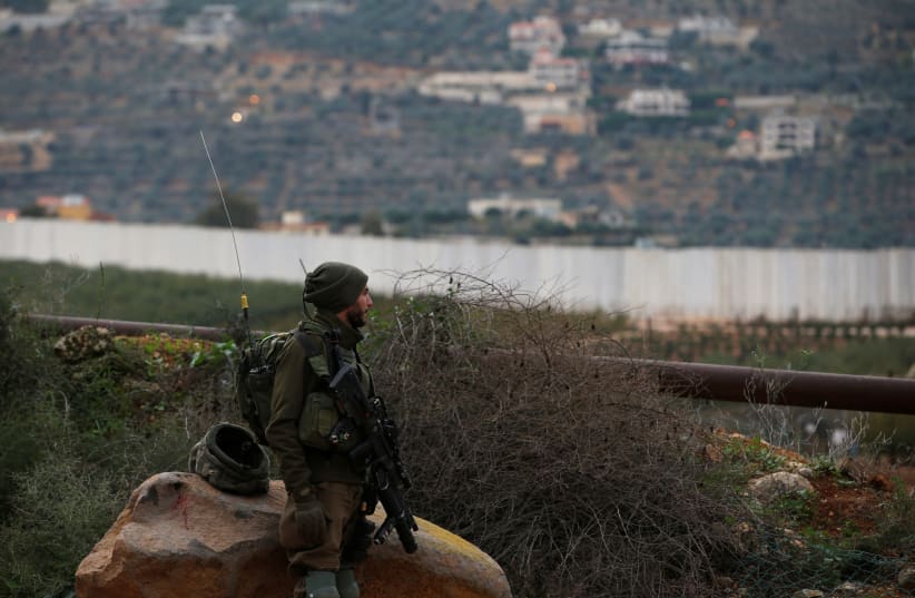 An Israeli soldier guards near the border with Lebanon, the morning after the Israeli military said it had launched an operation to "expose and thwart" cross-border attack tunnels from Lebanon, in Israel's northernmost town Metula December 5, 2018 (photo credit: REUTERS/Ronen Zvulun)