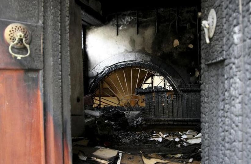 A burnt synagogue at Chania town on the Greek island of Crete (photo credit: REUTERS/GEORGE PAPANIKOLAOU)