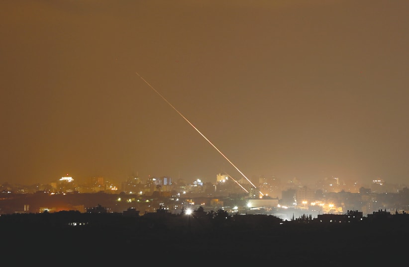 ROCKETS ARE launched from the northern Gaza Strip toward Israel, as seen from Sderot in August (photo credit: AMIR COHEN/REUTERS)