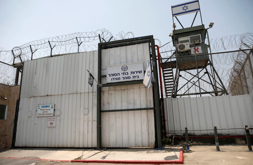 An Israeli flag is seen next to the gate of the Megiddo Prison in northern Israel July 24, 2018. Picture taken July 24, 2018.  (photo credit: REUTERS/AMIR COHEN)