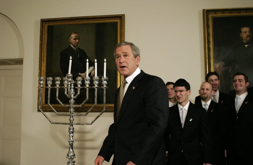 U.S. President George W. Bush looks on after a menorah was lit for Hanukkah at the White House in Washington December 9, 2004 (photo credit: REUTERS/SHAUN HEASLEY SH)