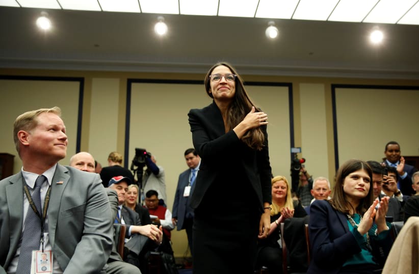Representative-elect Alexandria Ocasio Cortez (D-NY) crosses her self before drawing 40 during a lottery for office assignments on Capitol Hill in Washington, U.S., November 30, 2018 (photo credit: REUTERS/JOSHUA ROBERTS)