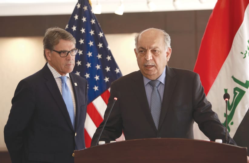 IRAQI OIL MINISTER Thamer Ghadhban (right) speaks during a press conference in Baghdad yesterday, as US Energy Secretary Rick Perry looks on. (photo credit: HADI MIZBAN/REUTERS)