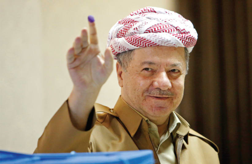KURDISTAN DEMOCRATIC Party leader Masoud Barzani shows his ink-stained finger after casting his vote during parliamentary elections in the semi-autonomous region on the outskirts of Erbil, Iraq, on September 30. (photo credit: REUTERS)