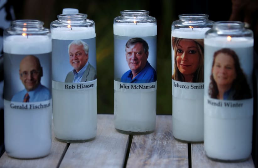 Candles representing the slain journalists of Capital Gazette sit on display during a candlelight vigil held near the Capital Gazette, the day after a gunman killed five people inside the newspaper's building in Annapolis, Maryland, U.S., June 29, 2018. (photo credit: REUTERS/LEAH MILLIS)