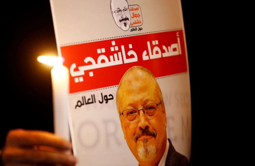  A demonstrator holds a poster with a picture of Saudi journalist Jamal Khashoggi outside the Saudi Arabia consulate in Istanbul, Turkey October 25, 2018. (photo credit: REUTERS/OSMAN ORSAL)
