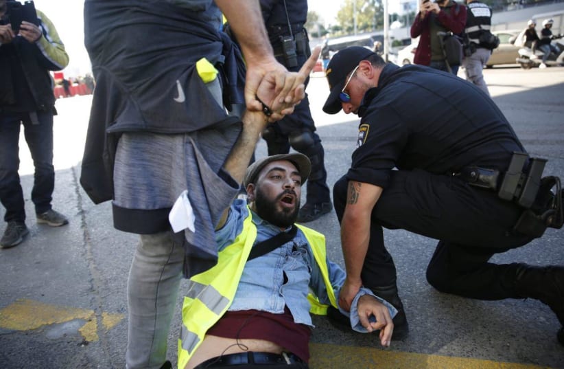 A demonstrator is arrested at a "Yellow Vest" protest in Tel Aviv, December 14, 2018 (photo credit: YELLOW VEST PROTEST HEADQUARTERS IN ISRAEL)