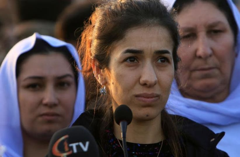 Nobel Peace Prize laureate, Yazidi activist Nadia Murad talks to people during her visit to Sinjar, Iraq December 14, 2018. (photo credit: ARI JALAL / REUTERS)