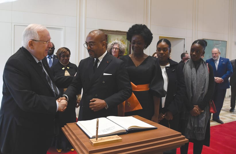 PRESIDENT REUVEN RIVLIN greets Ivory Coast Ambassador Vhangha Patrice Koffi, who is accompanied by his wife and daughters, after he presented his credentials. (photo credit: HAIM ZACH/GPO)