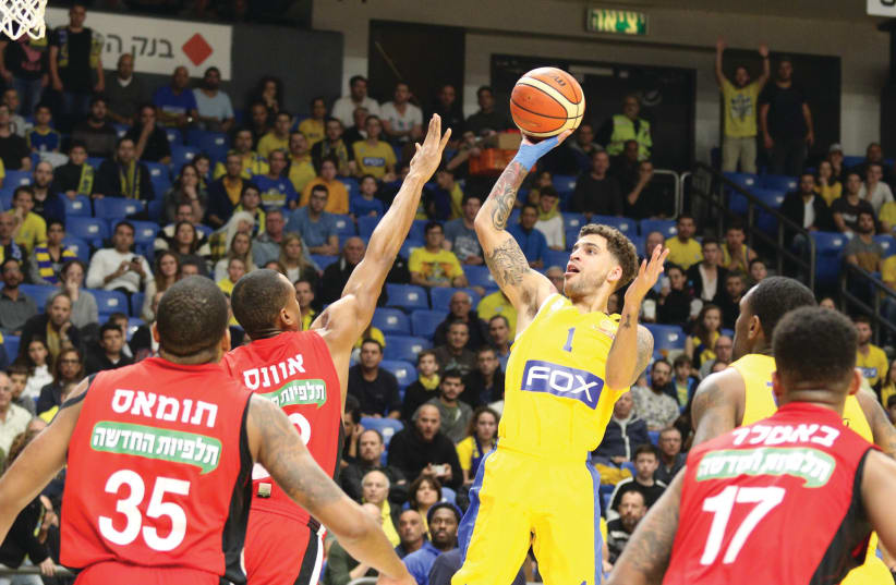 Maccabi Tel Aviv’s Scottie Wilbekin shoots over the Hapoel Jerusalem defense for two of his 20 points in Maccabi’s 91-78 home victory over Hapoel in Basketball Super League action this week (photo credit: ERAN LUF)