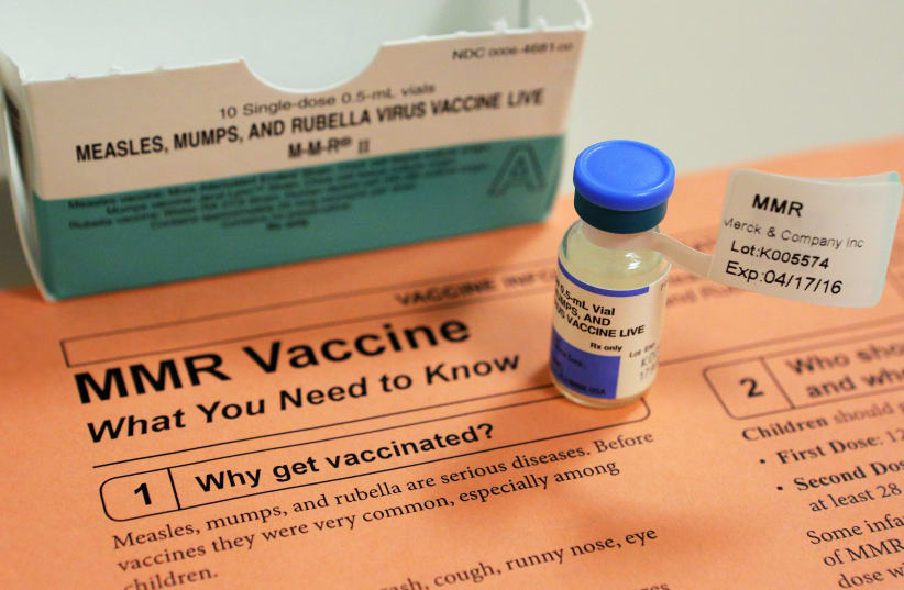 A vial of measles, mumps and rubella vaccine and an information sheet is seen at a hospital (photo credit: REUTERS/BRIAN SNYDER)