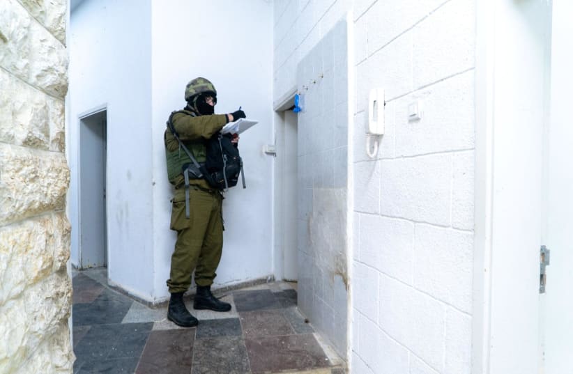 An IDF soldier maps out the home of the Barghouti brother terrorists  (photo credit: IDF SPOKESPERSON'S UNIT)