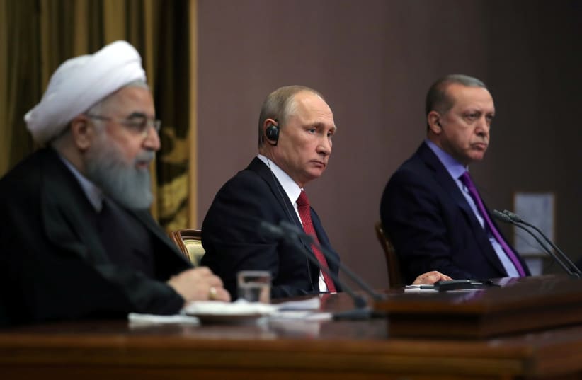 Iran's President Hassan Rouhani together with his counterparts, Russia's Vladimir Putin and Turkey's Tayyip Erdogan, attend a joint news conference following their meeting in Sochi, Russia November 22, 2017 (photo credit: SPUTNIK/MIKHAIL KLIMENTYEV/KREMLIN VIA REUTERS)