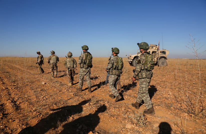 U.S. and Turkish soldiers conduct the first-ever combined joint patrol outside Manbij, Syria, November 1, 2018. Picture taken November 1, 2018. Courtesy Arnada Jones/U.S.  (photo credit: ARMY/HANDOUT VIA REUTERS)