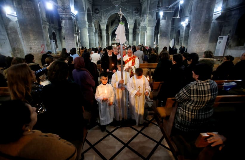 Iraqi Christians attend a mass on Christmas Eve at the Grand Immaculate Church in Qaraqosh (al-Hamdaniya), near Mosul (photo credit: THAIER AL-SUDANI/REUTERS)