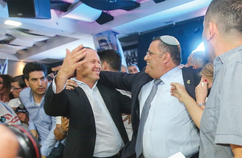 New Mayor Moshe Lion (right) embraced outgoing mayor Nir Barkat on November 14, when the runoff vote results were finalized. (photo credit: MARC ISRAEL SELLEM)