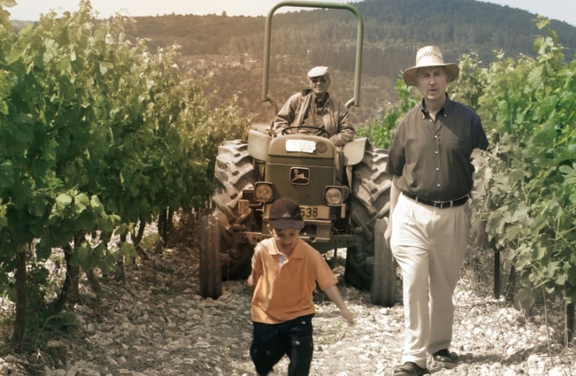 THE NEXT generation: Motti Shor walking the vineyard with his grandson. (photo credit: Courtesy)