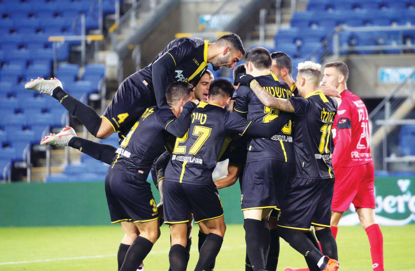 BEITAR JERUSALEM players celebrate their team’s second goal in a 3-0 surprise road victory over Hapoel Hadera last night in Premier League action (photo credit: UDI ZITIAT)