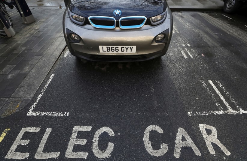 A car is parked at a charging point for electric vehicles in London, Britain, March 6, 2018. (photo credit: REUTERS/SIMON DAWSON)