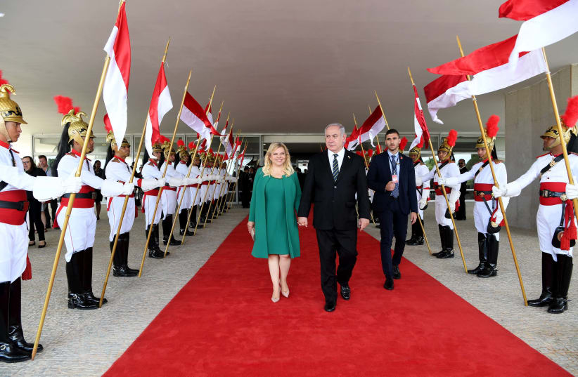 Prime Minister Benjamin Netanyahu and his wife Sara during a state visit to Brazil, December 2018 (photo credit: AVI OHAYON - GPO)