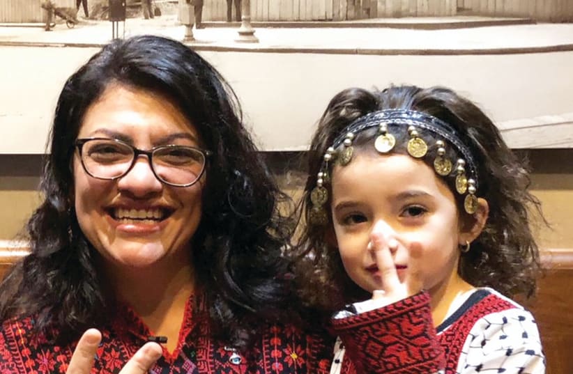 CONGRESSWOMAN RASHIDA TLAIB, the first Palestinian-American elected to the House, wears a traditional Palestinian robe at her swearing-in ceremony. (photo credit: REUTERS/ADAM SHAPIRO)