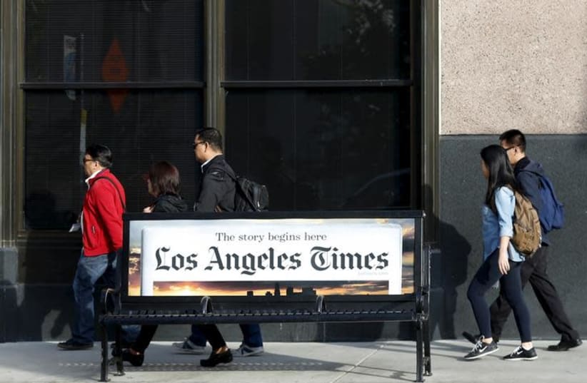 People walk past the building of Los Angeles Times newspaper, which is owned by Tribune Publishing Co, in Los Angeles, California, U.S. on April 27, 2016 (photo credit: REUTERS/LUCY NICHOLSON)