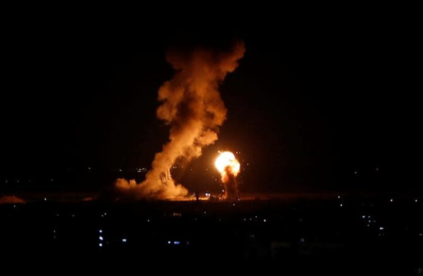 Smoke and flame are seen during an Israeli air strike in Gaza, November 12, 2018 (photo credit: AHMED ZAKOT / REUTERS)